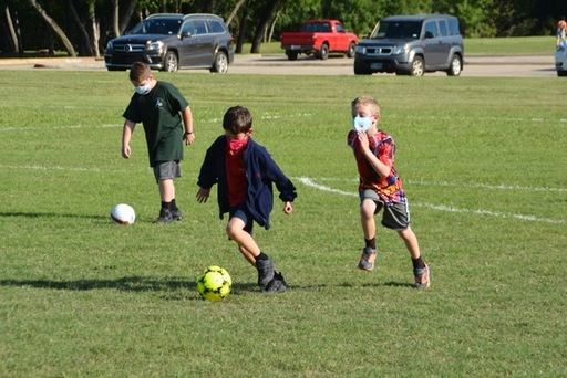 Kids in Masks Playing Soccer.jpeg
