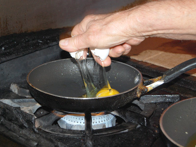 Cracking egg into skillet with one hand.jpg