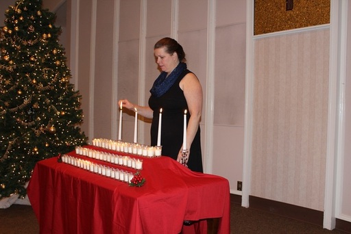 Stephanie Hughes lights a candle.jpg